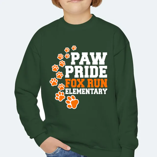 A looping trail of paw prints, PAW PRIDE at Fox Run Elementary, on a forest green youth crewneck