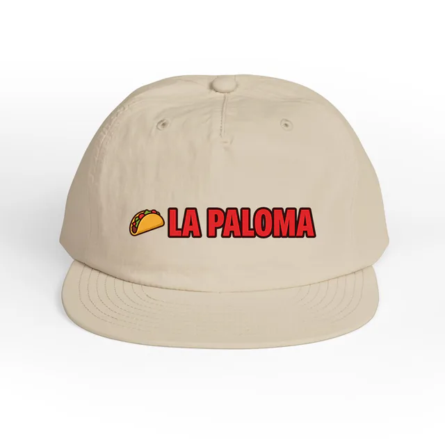 A taco beside LA PALOMA, on an ecru surf cap