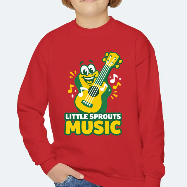 A grinning ukulele with bouncing notes, LITTLE SPROUTS MUSIC, on a red youth crewneck