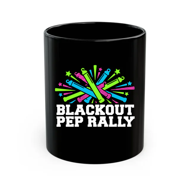Crisscrossed glow sticks, BLACKOUT PEP RALLY, on a black mug
