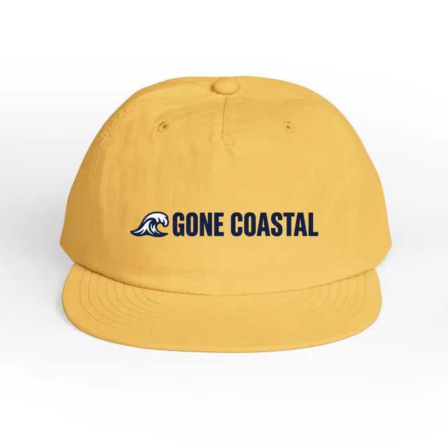 A curling wave beside GONE COASTAL, on a sunset surf cap