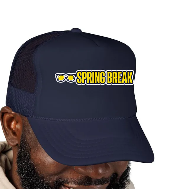 A pair of sunglasses beside SPRING BREAK, on a navy foam trucker hat