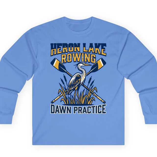 A heron and crossed oars for Heron Lake Rowing dawn practice, on a carolina blue adult long sleeve