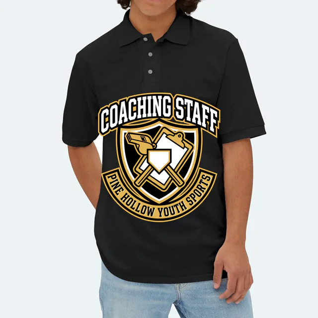 A whistle and clipboard crest for the Pine Hollow coaching staff, on a black adult polo