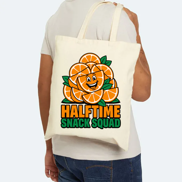 A grinning orange wedge for the HALFTIME SNACK SQUAD, on a natural canvas tote