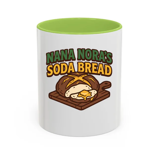 A buttered loaf of NANA NORA'S SODA BREAD, on a light green accent mug