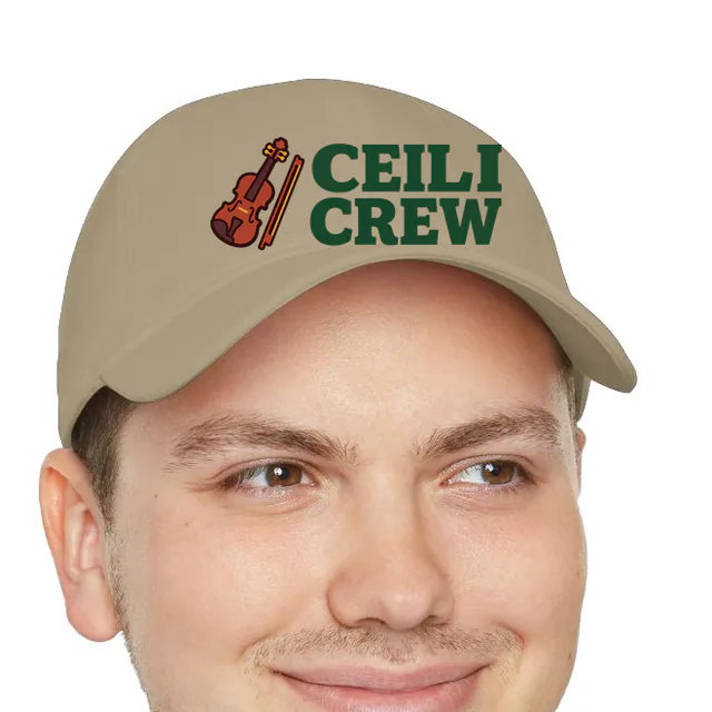 A fiddle and bow beside CEILI CREW, on a khaki dad hat