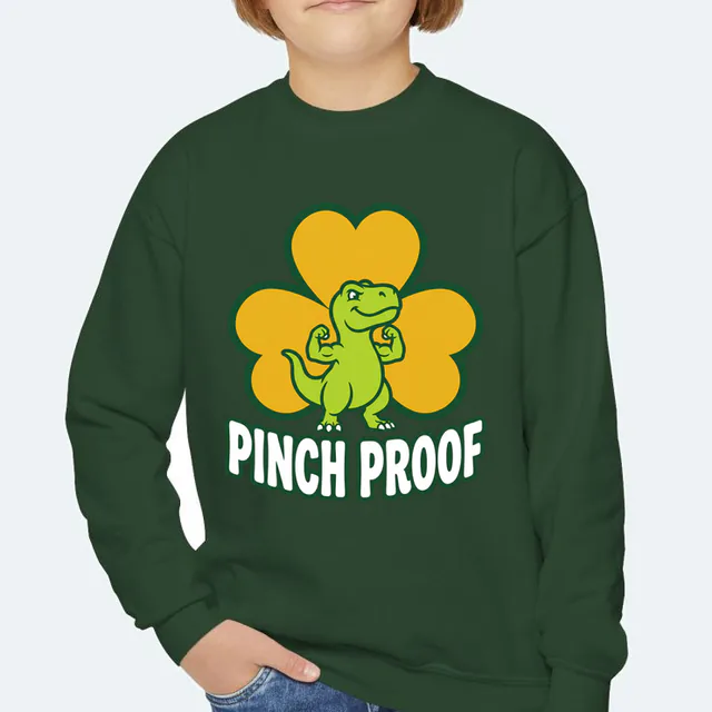 A flexing green dinosaur over PINCH PROOF, on a forest green youth crewneck