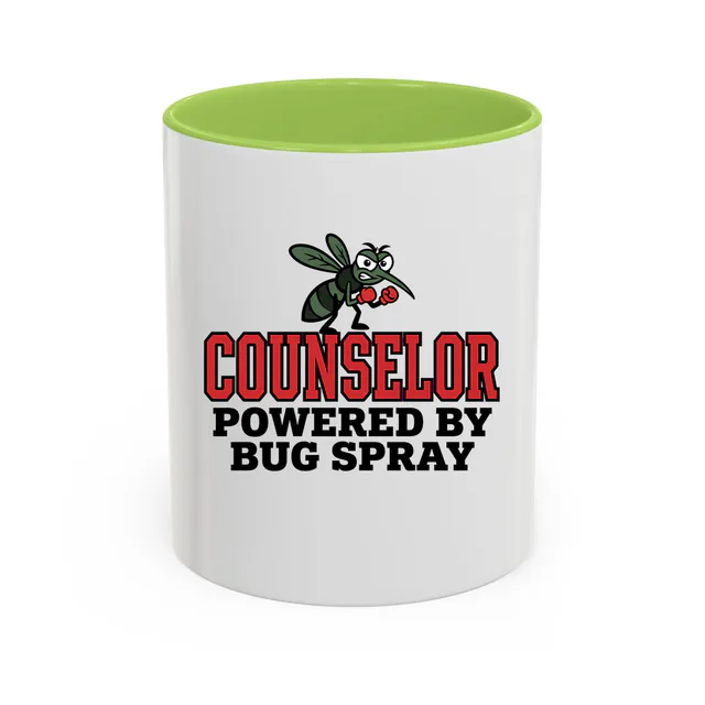 A mosquito in boxing gloves, COUNSELOR POWERED BY BUG SPRAY, on a light green accent mug