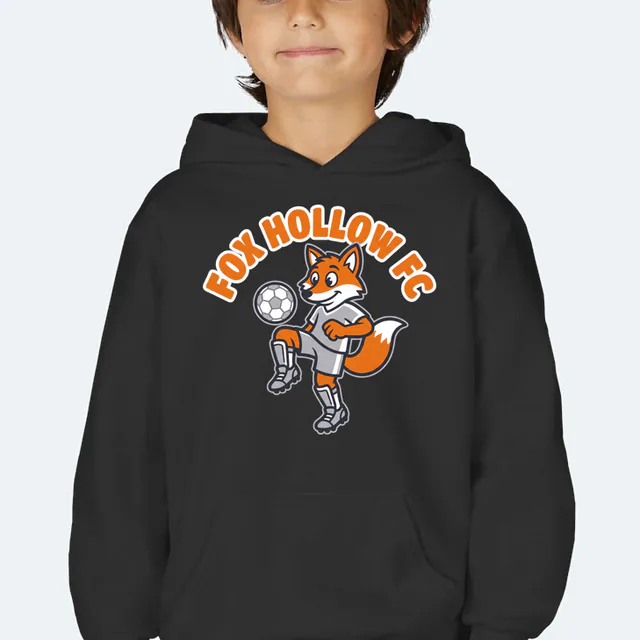 A fox juggling a soccer ball under FOX HOLLOW FC, on a black youth hoodie
