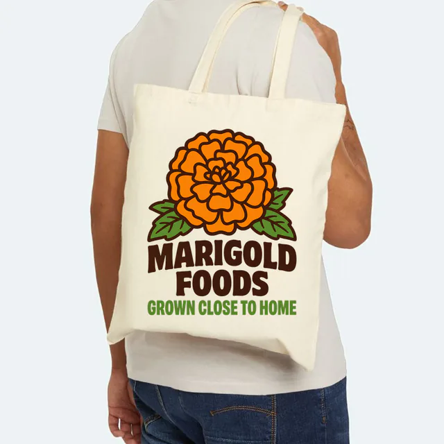 A big marigold bloom, MARIGOLD FOODS, on a natural canvas tote