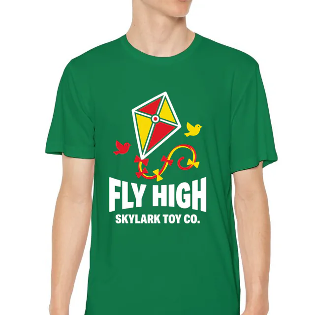 A diamond kite with a curling tail, FLY HIGH, on a kelly green youth performance tee