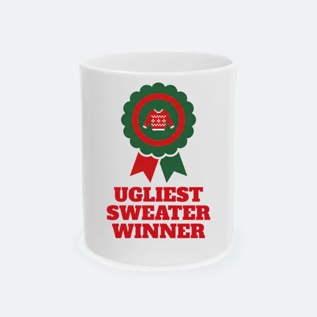 A prize rosette with a tiny sweater, UGLIEST SWEATER WINNER, on a white ceramic mug