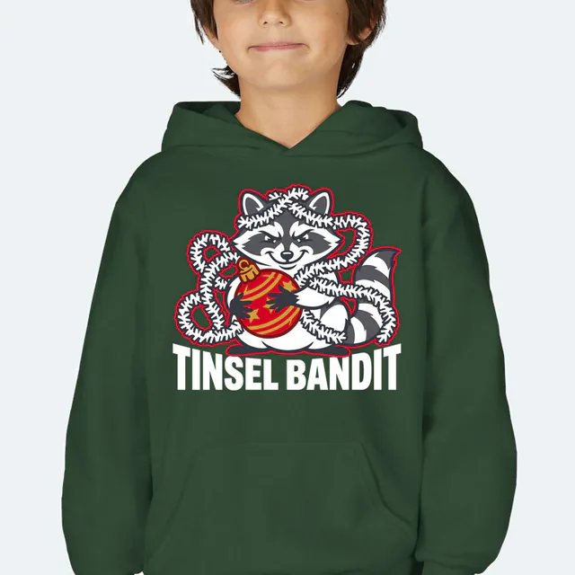 A raccoon wrapped in tinsel with a stolen ornament, TINSEL BANDIT, on a forest green youth hoodie