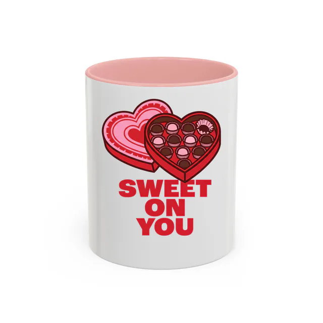 A heart-shaped chocolate box missing one piece, SWEET ON YOU, on a pink accent mug