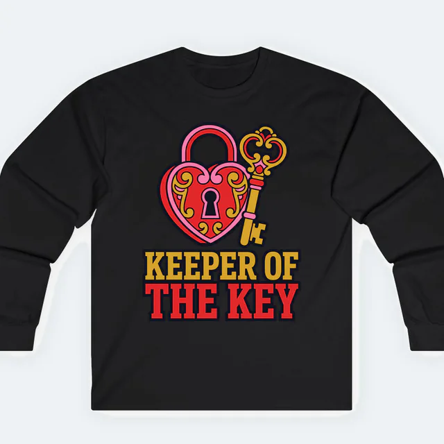 A heart-shaped padlock and key, KEEPER OF THE KEY, on a black adult long sleeve