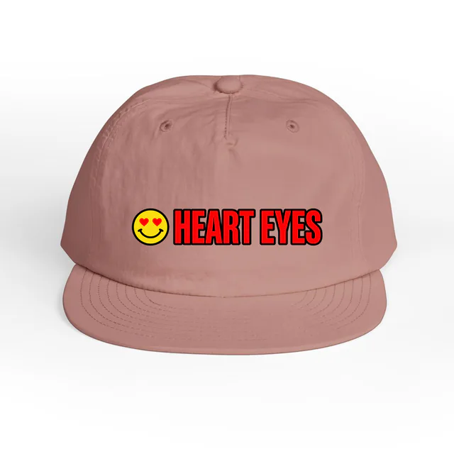 A heart-eyed smiley beside HEART EYES, on a hazy pink surf cap