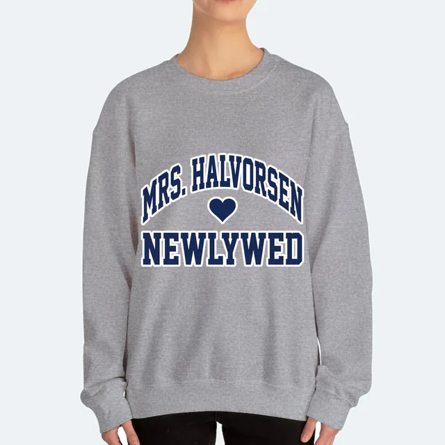 MRS. HALVORSEN arched over a heart, NEWLYWED, on a sport gray adult crewneck