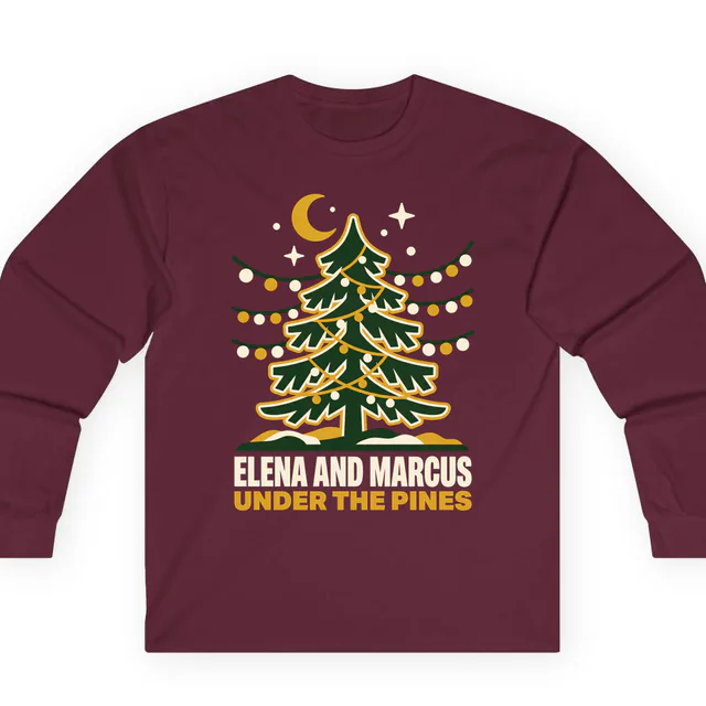 String lights in a tall pine, UNDER THE PINES, on a maroon adult long sleeve