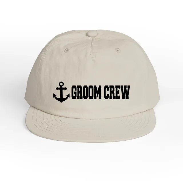 An anchor beside GROOM CREW, on a bone surf cap