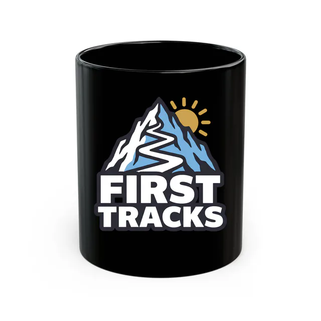 A ski trail zigzagging down a peak, FIRST TRACKS, on a black mug