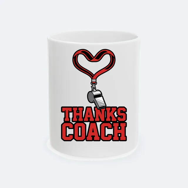 A whistle lanyard looped into a heart, THANKS COACH, on a white ceramic mug