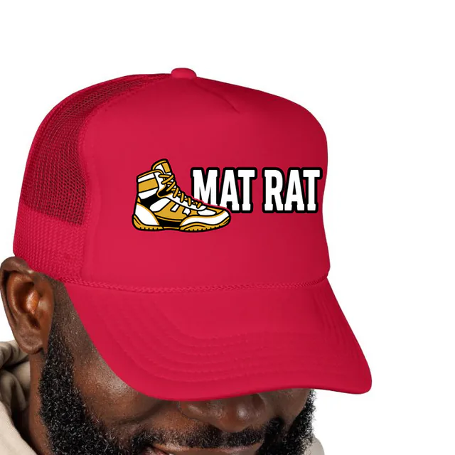 A wrestling shoe beside MAT RAT, on a red foam trucker hat