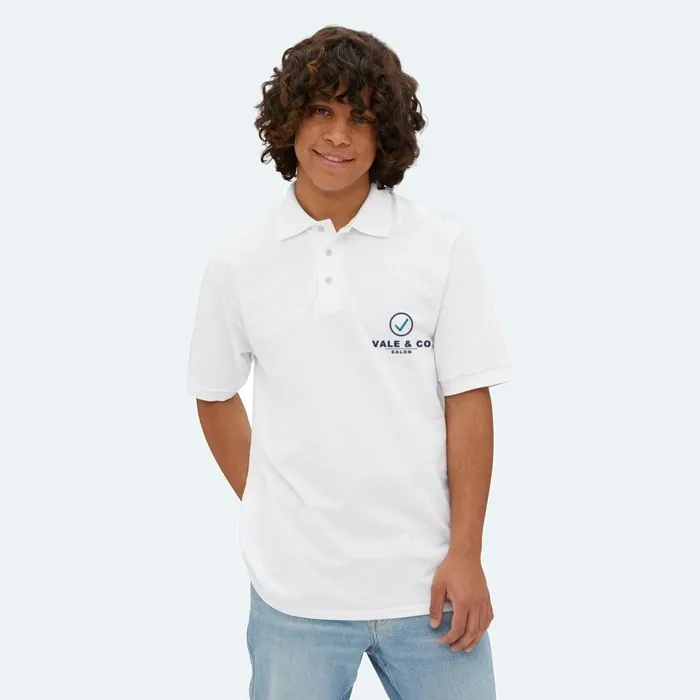 A white polo with a small Vale and Co salon mark on the left chest