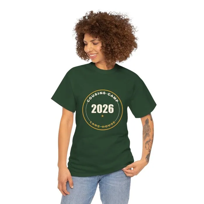 A forest green t-shirt printed with a Cousins Camp 2026 lake house badge