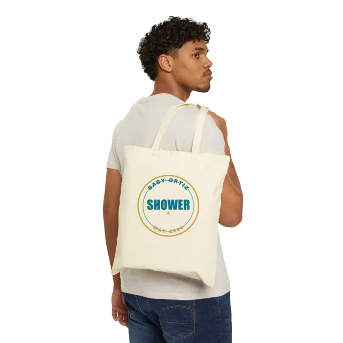 A natural canvas tote printed with a Baby Ortiz shower badge