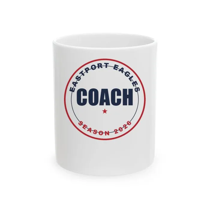 A white ceramic mug printed with a navy Eastport Eagles coach badge
